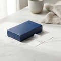 Nidra Hush Mouth Tape navy box with a single strip on white marble